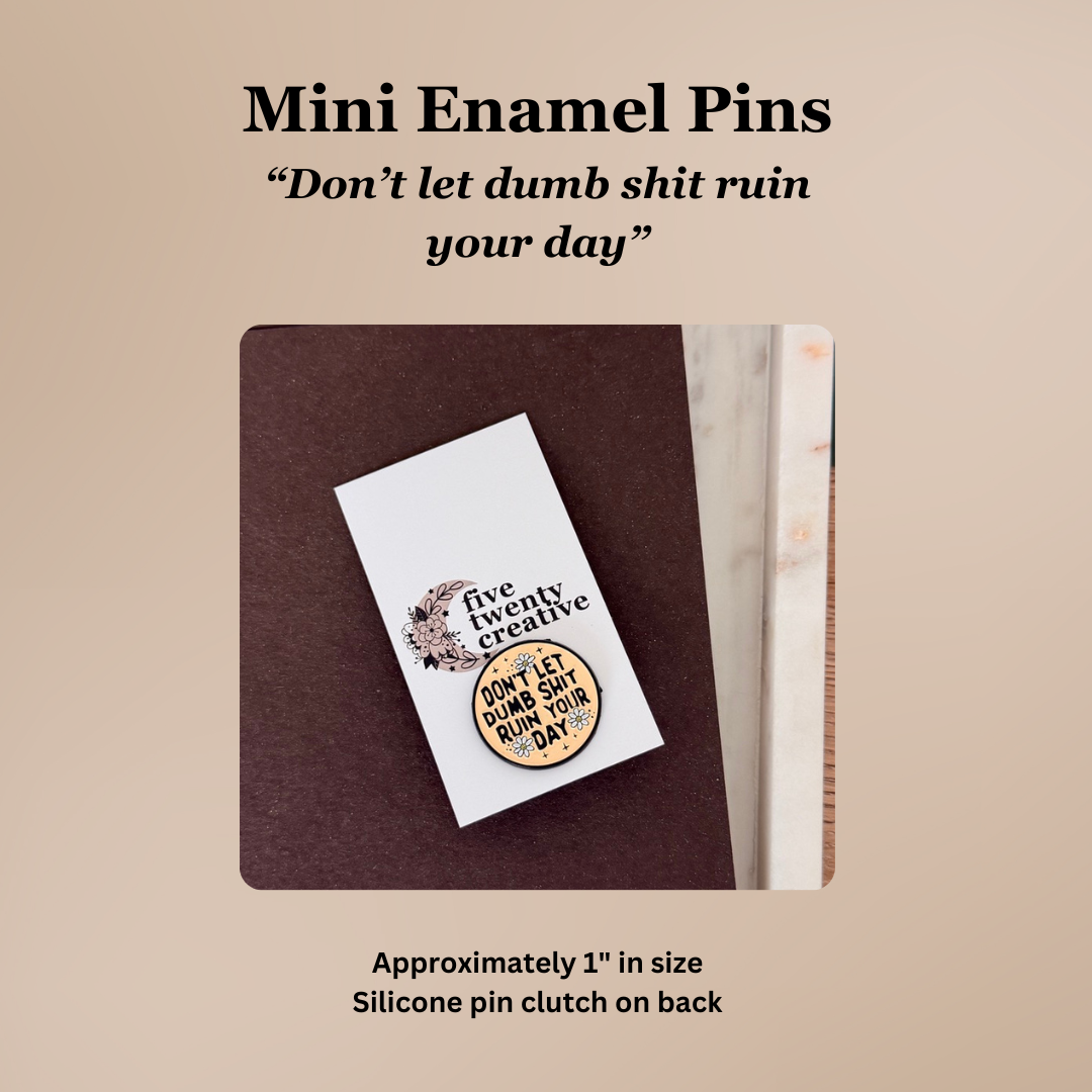 Mini enamel pin with motivational quote on a beige background